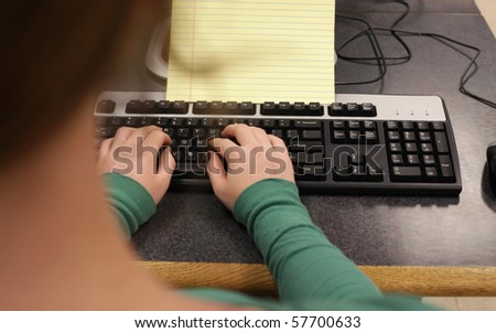 Over the shoulder view of girl at keyboard