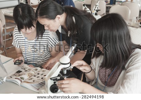 OSAKA, JAPAN -AUGUST 20 : unidentified students categorising microorganism on biology lab on 20 AUGUST 2014 with sepia style processed