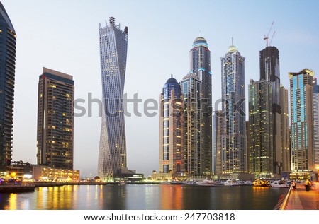 The United Arab Emirates. The Dubai Waterfront.\
On the banks of the lagoon Dubai are high-rise modern buildings to the waterfront moored a large number of boats .