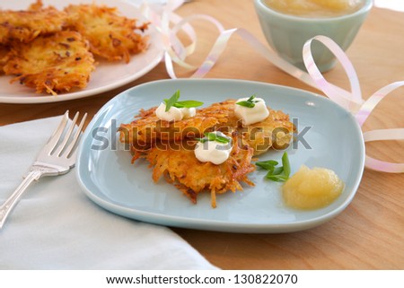 Latkes, or potato pancakes with applesauce, sour cream and onions, traditionally served at Hanukkah
