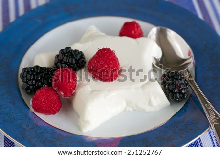 Star-shaped panna cotta with black berries and raspberries