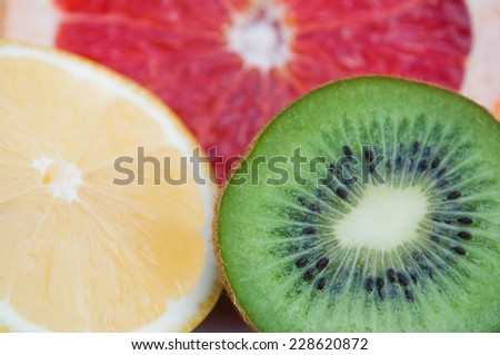 Fresh colorful tropical fruits - lemon, kiwi, red grapefruit