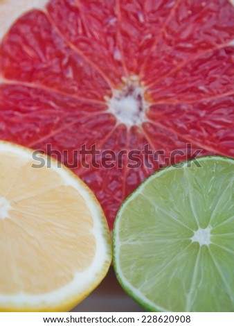 Fresh colorful tropical fruits - lemon, lime, red grapefruit. Vertical image
