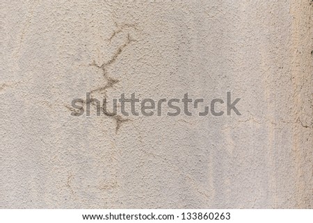 Wet cement crack on white wall