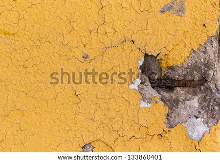 Details of a concrete yellow divider wall falling apart