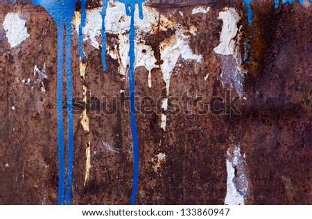 Blue and white paint spill on rusted metal texture