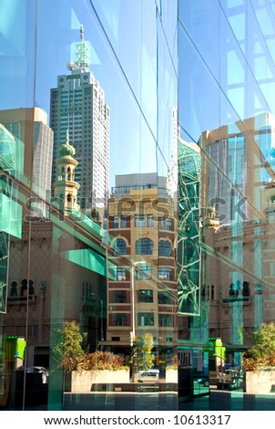 A street scene, reflected in the glass facade of a nearby inner-city office building, Melbourne, Australia
