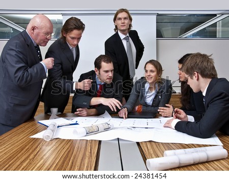 A company manager, and his team, discussing plans in a modern  office
