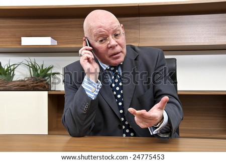 A company director engaged in tense negotiations during a mobile telephone conversation