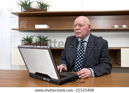 A company director checking data on his laptop