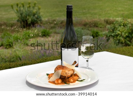 Free Range pan-seared Chicken Breast Fillet filled with Soft Cheese and Pesto, set on Gnocchi, topped with a Tomato & Basil Sauce, accompanied by a glass of Chardonnay