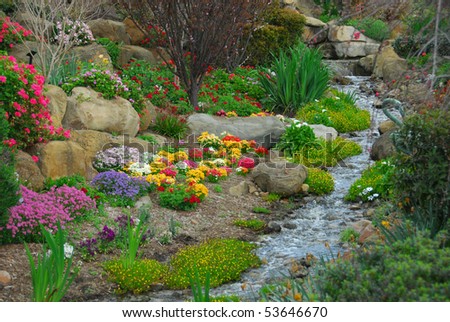 A rock garden, complete with running stream and flowering plants