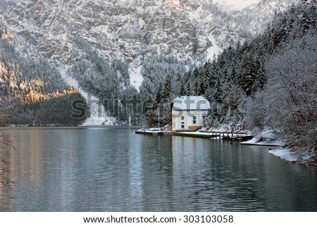 A picturesque winter reflection scene, in a partly frozen lake, Austria
