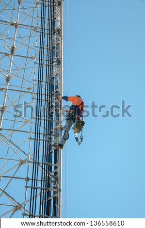 Tower climber and working on cellular tower system.