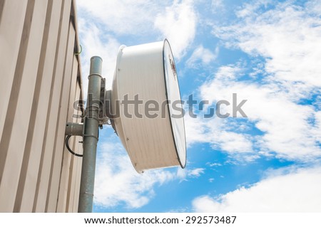 Microwave antenna on the wall of building.