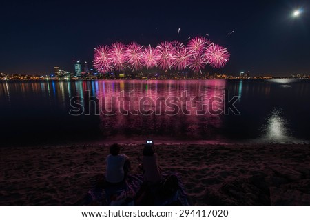 Perth Australia Day Skyworks which is the biggest Australia day fireworks display in Australia celebrating the nation\'s federation. Fireworks over city with reflection in Swan river, Perth city.