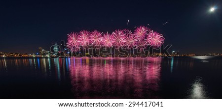 Perth Australia Day Skyworks which is the biggest Australia day fireworks display in Australia celebrating the nation's federation. Fireworks over city with reflection in Swan river, Perth city.