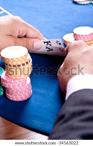 hands of a man with a card for the poker table
