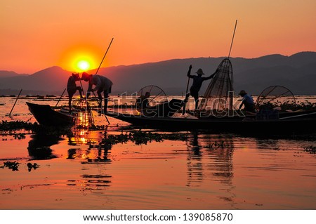 Fishermen in Inle lakes sunset.Fishermen is finish a day of fishing in Inle lake, Myanmar (Burma). Inle is one of the most favorite tourist places in Myanmar (Burma)
