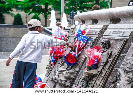WASHINGTON, D.C. - MAY 27: People visit and lay flowers at the United States Navy Memorial on May 27, 2013, in Washington, D.C.