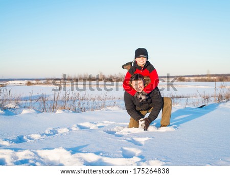 Father and son playing in snow. Happy family. Winter.