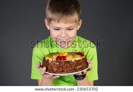 Cute funny boy staring longingly at cake.