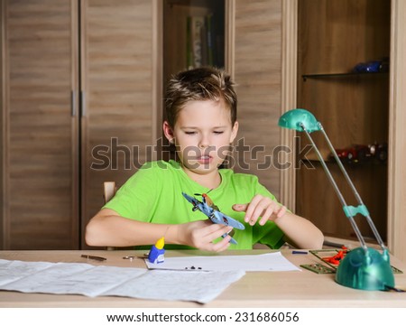 Creating the model plane. Happy boy making aircraft model. Hobby concept.