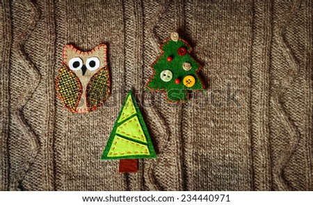 Handmade Christmas decoration on warm knitted background. New year concept. Vintage christmas card with handmade decor.