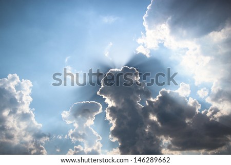 epic cloud landscape with rays of sunlight streaming through the clouds