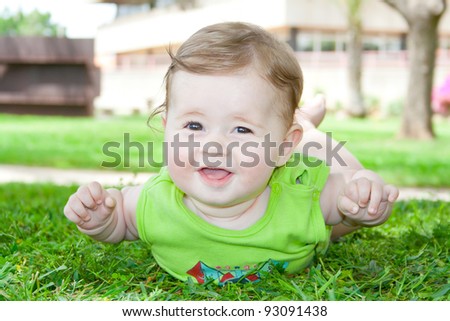 Smiling baby lying and played in the park