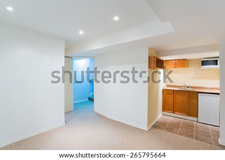 Empty basement living room with kitchen design
