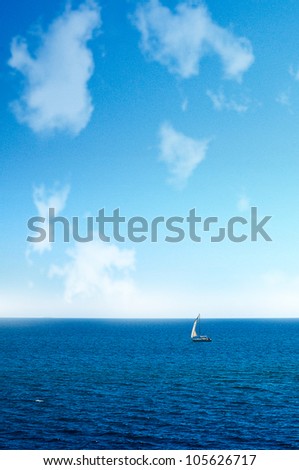 Blue sky and ocean and a sailboat