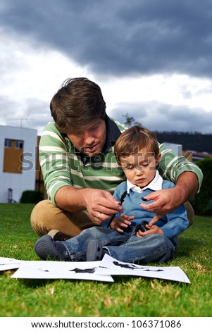 Father and son moment: Father teaching his son how to paint