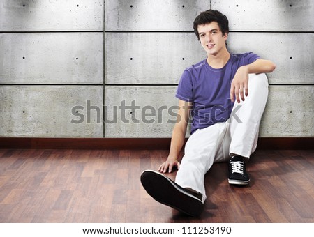Young man sitting in empty room