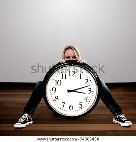 Happy woman with a big clock: Time Concept