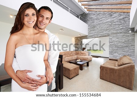 Young happy couple at their big new house