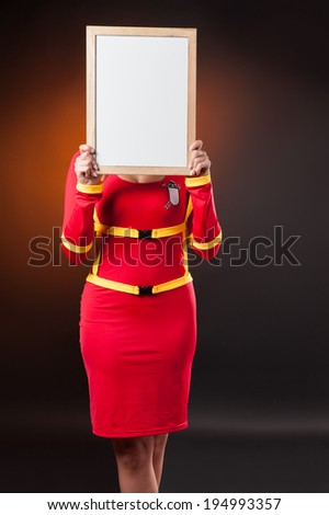 Firefighter woman holding white empty banner
