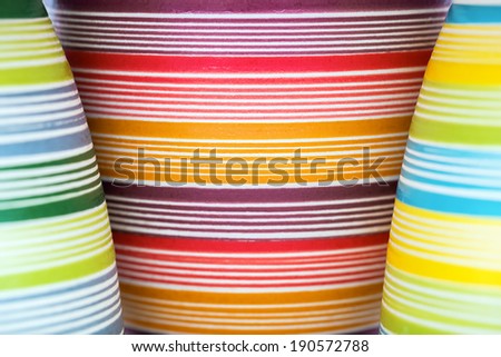 Three flower pots in bright colored stripes