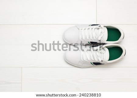 White sneakers on white wooden floor