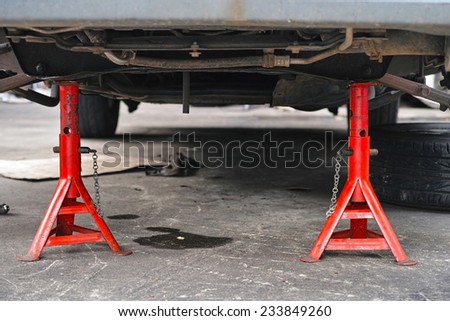 Car sitting on jack stand with front wheel removed
