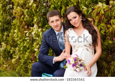 Happy newlyweds in park. Portrait of loving young bride and groom.