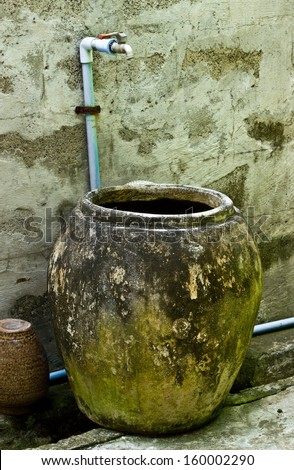 Old water jar with faucets