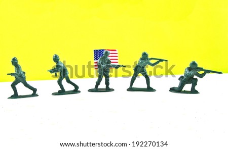 Plastic toy US Army with the american flag on the background