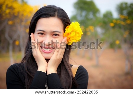 Young happy woman smiling with flower.