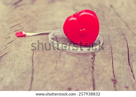 Love gauge concept. Red cartridges meters with heart shaped on wooden background. (filter image)