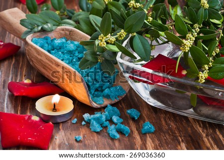 The composition of flowers, sea salt, water and a candle