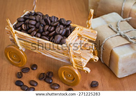 Composition with grains of coffee, soap and decorative objects on a wooden background