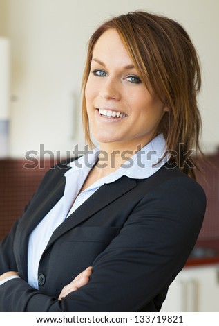 Young business woman in navy blue suit.