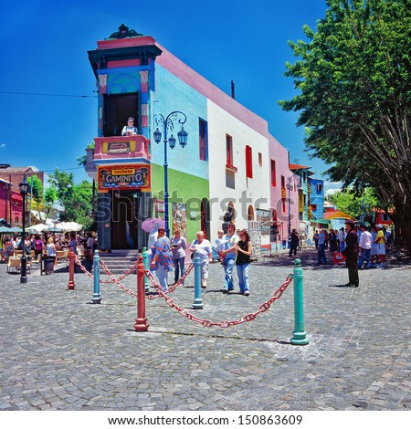 BUENOS AIRES, ARGENTINA - CIRCA DEC 2009: Unidentified tourists walks on the street. La Boca is a popular destination for tourists visiting Argentina, with its colorful houses and pedestrian street.