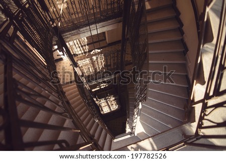 Old Architectural spiral marble stairs with black wrought iron railings in old building, palace